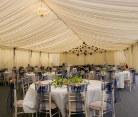 Decorated tables inside Meadow Tree Marquee